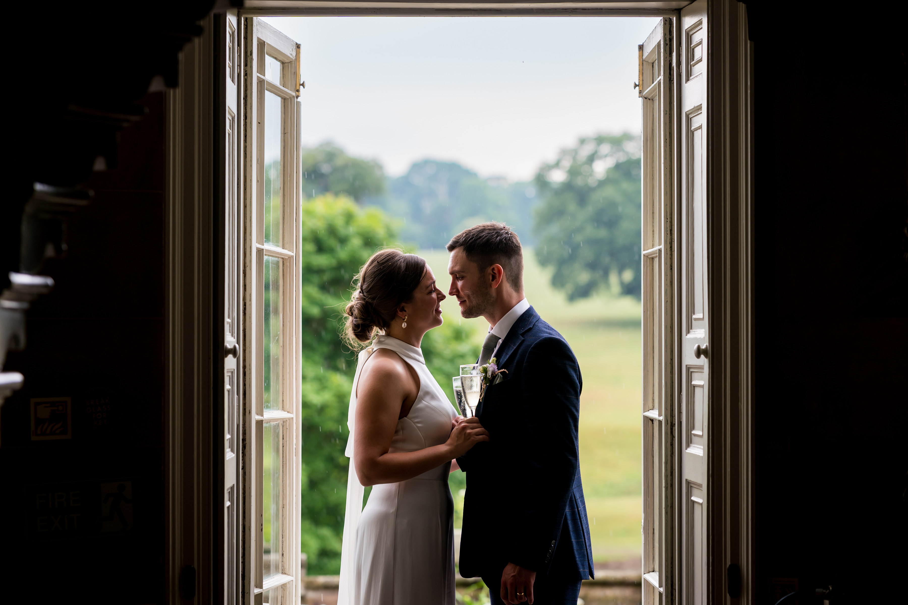 In the doorway, glasses in hand, the original photograph
